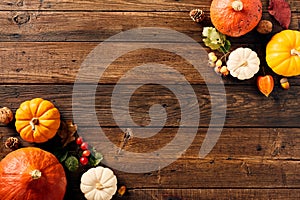 Autumn wooden background with pumpkins, fall leaves, berries. Thanksgiving, Halloween, Harvest concept. Flat lay composition, top