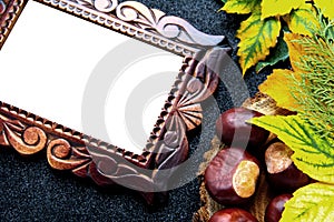 Autumn wooden frame. Carved frame on a black background with leaves