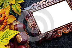 Autumn wooden frame. Carved frame on a black background with leaves