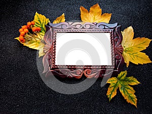 Autumn wooden frame. Carved frame on a black background with leaves