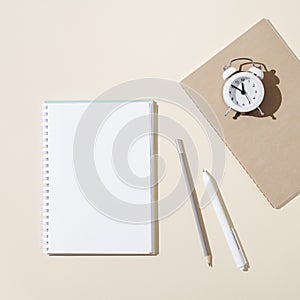 Autumn working space with open notebook with blank pages and white clock show day time. Autumnal time and mood concept.