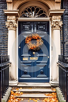 Autumn wreath decoration on a classic door entrance, welcoming autumn holiday season with autumnal decorations