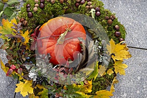 Autumn wreath with pumpkin, leaves and berries