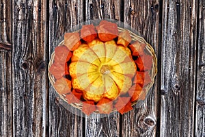 Autumnal Basket with Decorative Gourd and Physalis on Wooden Background