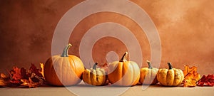 Autumnal charm with pumpkins and leaves on a beige table a cozy and festive Thanksgiving or Halloween setting