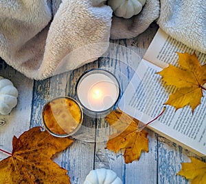 Autumnal composition with candle and yellow leaves