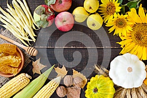 Autumnal food background. Crop of vegetables and fruit on wooden background.