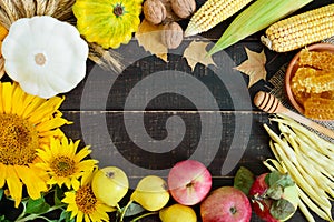 Autumnal food background. Crop of vegetables and fruit on wooden background