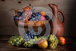 Autumnal fruit still life with Georgian jug on rustic wooden tab