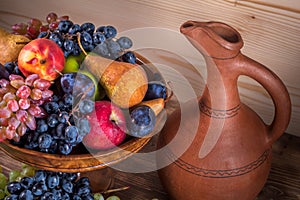 Autumnal fruit still life with Georgian jug on rustic wooden tab