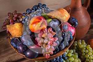 Autumnal fruit still life with Georgian jug on rustic wooden tab