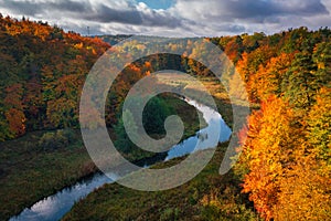 Autumnal landscape of the forest and twisted Radunia river in Kashubia. Poland photo