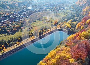 Autumnal landscape view of a mountain village and a lake