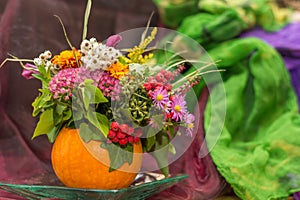 Autumnal pumpkin decoration with flowers