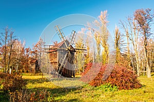 Autumnal Serenity: Wooden Windmill in Rural Landscape