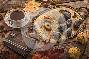 Autumnal still life with gift of nature , vintage notebook and tea with film filter effect