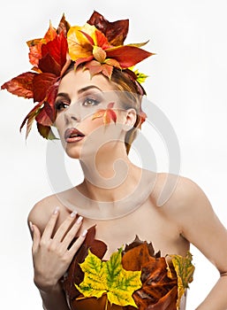 Autumnal woman. Beautiful creative makeup and hair style in fall concept studio shot. Beauty fashion model girl with fall makeup