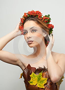 Autumnal woman. Beautiful creative makeup and hair style in fall concept studio shot. Beauty fashion model girl with fall makeup