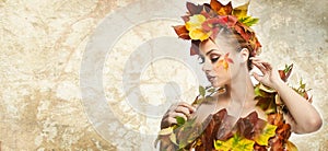 Autumnal woman. Beautiful creative makeup and hair style in fall concept studio shot. Beauty fashion model girl with fall makeup