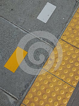 Auxiliary lines and yellow signs for people with disabilities photo
