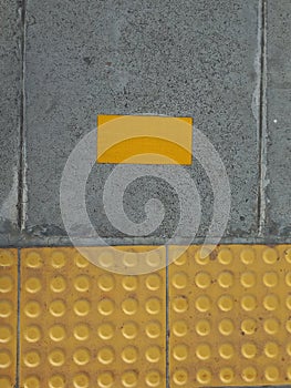 Auxiliary lines and yellow signs for people with disabilities found on train station platforms of various compositions. photo
