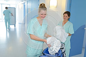 Auxiliary nurses collecting laundry photo