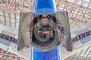 Auxiliary power plant in the tail of the aircraft with open hood covers.