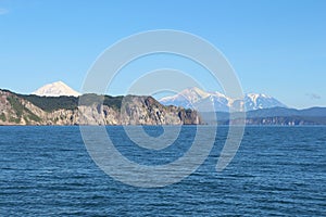 Avachinsky and Koryaksky volcanoes rises above the coastline of the Kamchatka Peninsula.