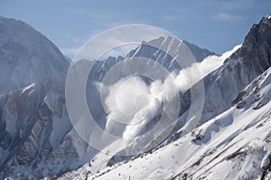 avalanche buries entire mountain range, with only peaks visible above the snow