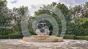 The Avalokitesvara Bodhisattva Buddha statue is in garden that is a graceful