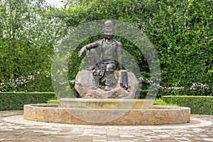 The Avalokitesvara Bodhisattva Buddha statue is in garden that is a graceful