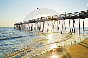 Avalon Pier and beach at the Outer Banks of North Carolina at sunrise photo