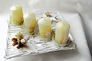 Avantgarde home made advent wreath with line of yellow candles