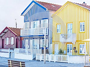 Aveiro, Portugal â€“ May 3, 2019: Street with colorful traditional fisherman houses in the famous Costa Nova, Aveiro.