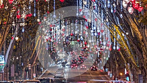 Avenida da Liberdade in Lisbon illuminated with lights hanging from the trees night timelapse. Portugal