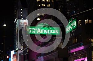 Avenue of the Americas and 42nd st. corner street sign in Bryant Park. New York City.