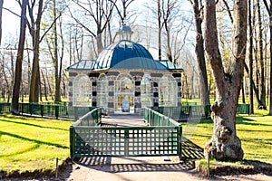 Aviary pavilion in The Lower Gardens in Peterhof in spring sunny day