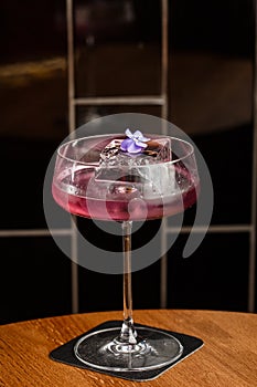 Aviation, drink with gin, lemon juice,maraschino liqueur and violet cream liqueur standing on bar counter