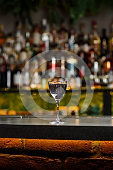 Aviation, drink with gin, lemon juice, maraschino liqueur and violet cream liqueur standing on bar counter.