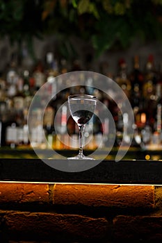 Aviation, drink with gin, lemon juice, maraschino liqueur and violet cream liqueur standing on bar counter.