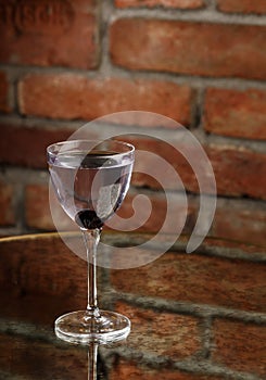 Aviation, drink with gin, lemon juice, maraschino liqueur and violet cream liqueur standing on bar counter.