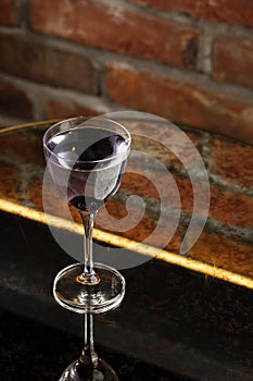 Aviation, drink with gin, lemon juice, maraschino liqueur and violet cream liqueur standing on bar counter.