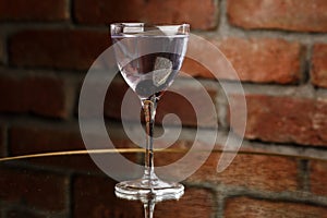 Aviation, drink with gin, lemon juice, maraschino liqueur and violet cream liqueur standing on bar counter.