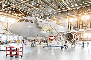 Aviation hangar with passenger aircraft jet for maintenance