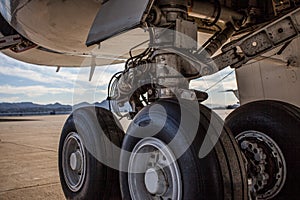 Aviation: Huge airplane wheels with black tires on tarmac