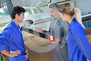 Aviation students looking at propellor aircraft