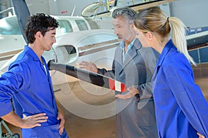 Aviation students looking at propellor aircraft photo