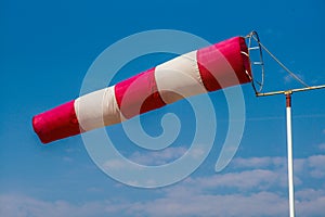 Aviation weather - windsock wind vane with blue and light cloudy sky in the background