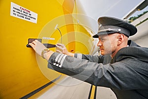 Aviator closing the fuselage door after landing