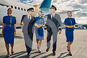 Aviators and beautiful flight attendants going ahead